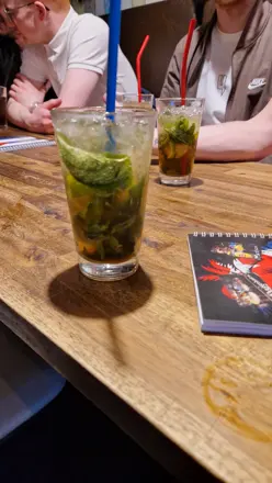 Two mojitos on a wooden table