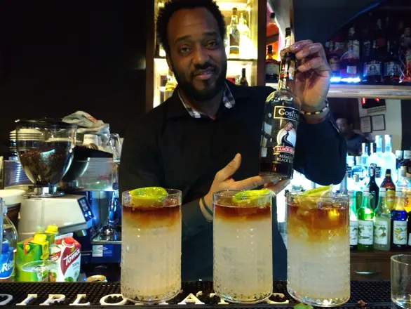Four Cuba Libres lined up on the bar